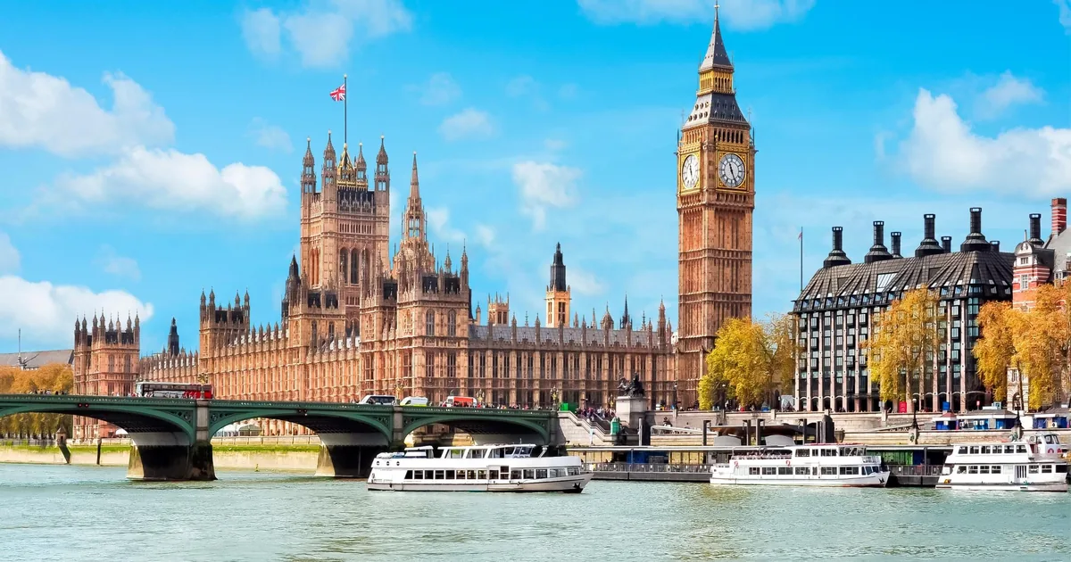 Sightseeing boats on the Thames by Westminster Bridge with the Houses of Parliament and Big Ben behind